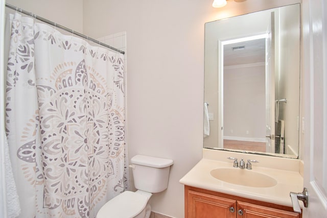 bathroom featuring walk in shower, vanity, and toilet