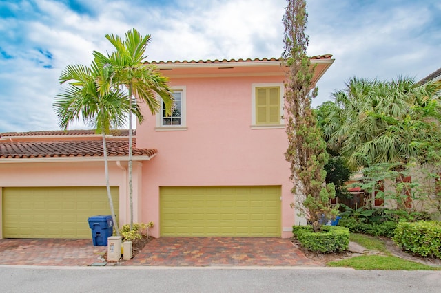 mediterranean / spanish-style house with a garage