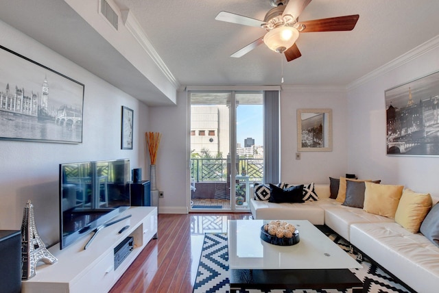 living room featuring wood-type flooring, a textured ceiling, crown molding, and ceiling fan