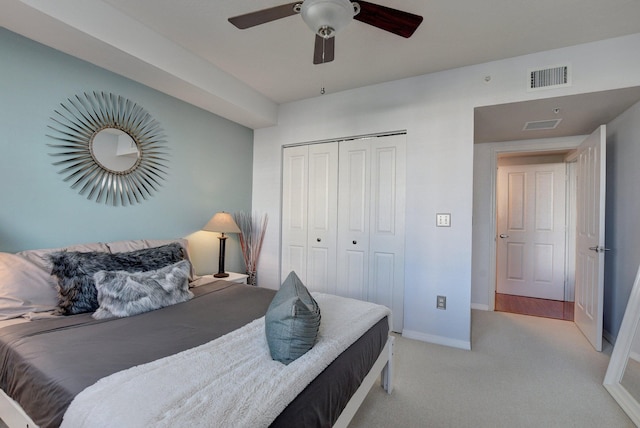 carpeted bedroom with a closet and ceiling fan