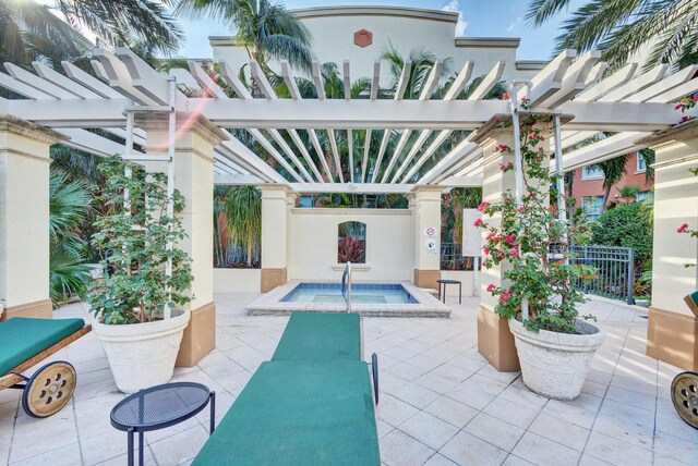 view of patio with a pergola and an in ground hot tub