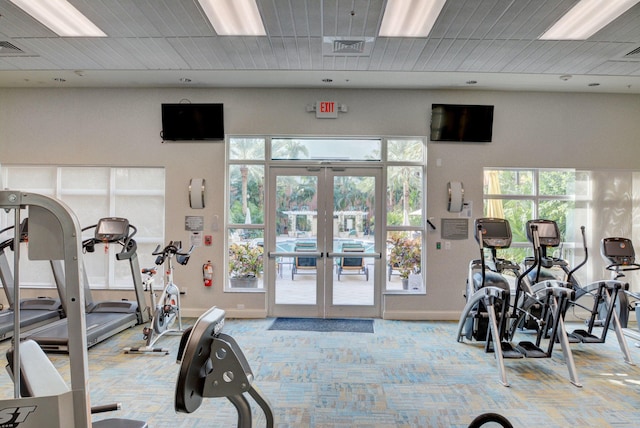 workout area with light colored carpet and french doors