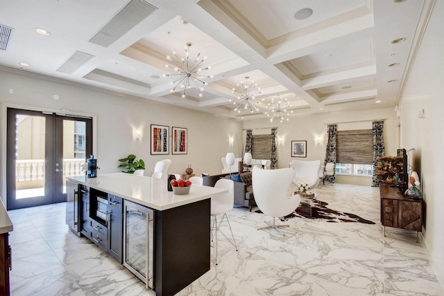 kitchen with a wealth of natural light, beam ceiling, coffered ceiling, and french doors