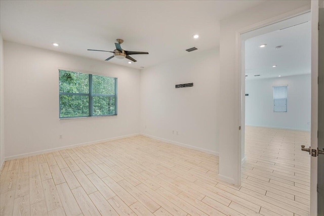 unfurnished room with light wood-type flooring and ceiling fan