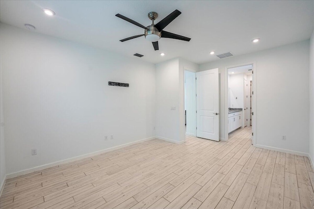 empty room featuring ceiling fan and light hardwood / wood-style flooring