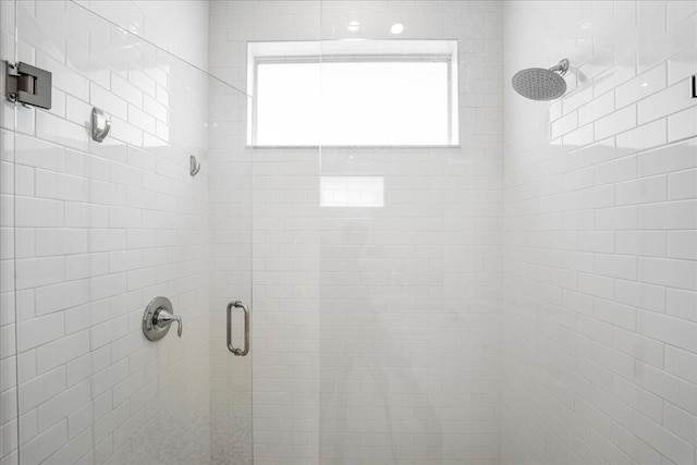 bathroom with a shower with shower door