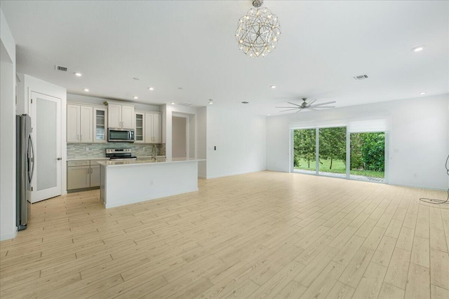 interior space with light hardwood / wood-style flooring, ceiling fan, and sink