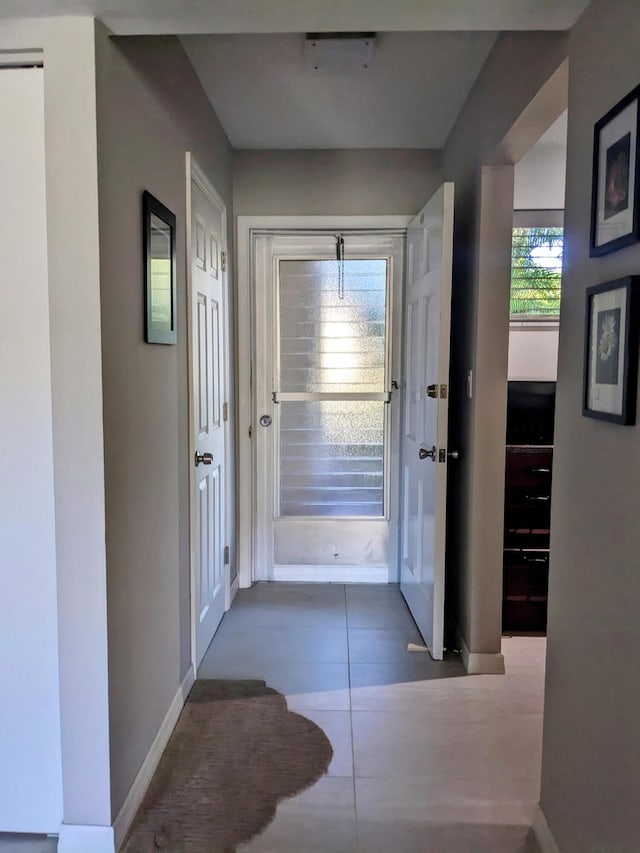 entryway with dark tile patterned flooring