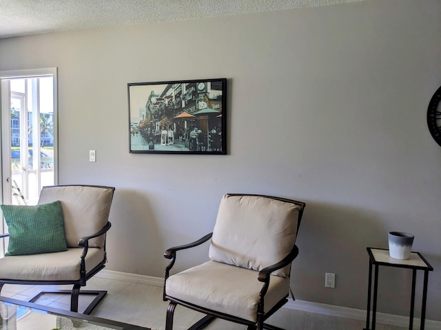 living area featuring a textured ceiling