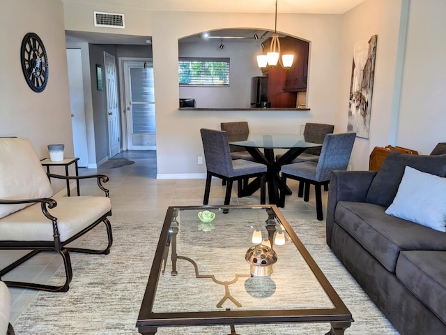 tiled living room with a chandelier