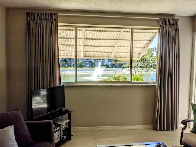 living area featuring a textured ceiling