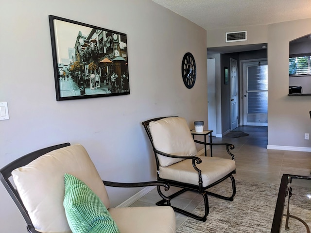 sitting room featuring a textured ceiling