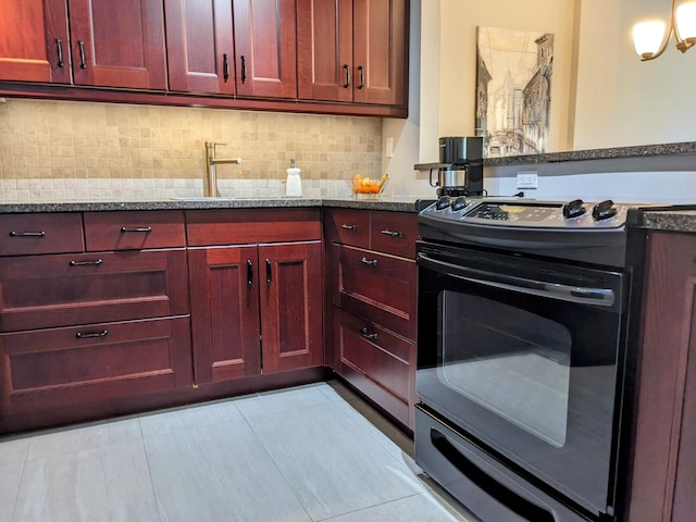 kitchen with black electric range oven, light stone countertops, sink, and tasteful backsplash