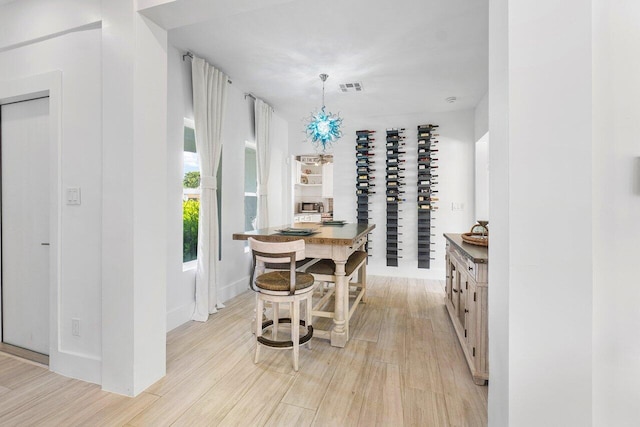 kitchen with butcher block counters, light wood-type flooring, and hanging light fixtures