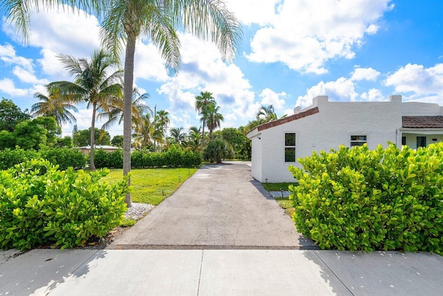 view of property exterior with a yard