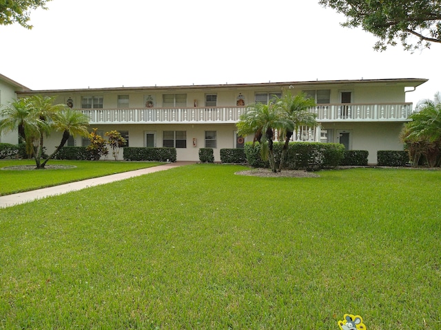 exterior space featuring a balcony and a yard