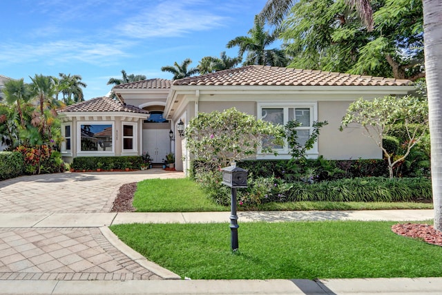 mediterranean / spanish house with a front yard