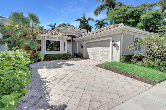 mediterranean / spanish home with a garage