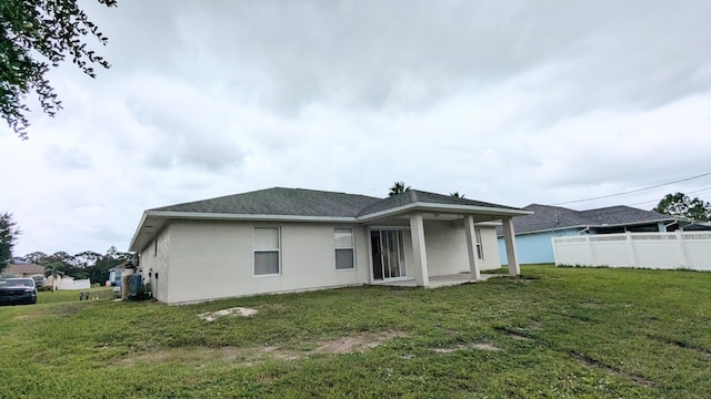 back of house featuring a lawn