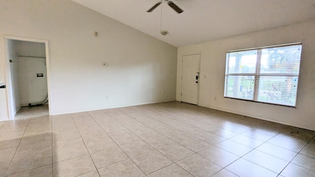 tiled empty room featuring ceiling fan and lofted ceiling