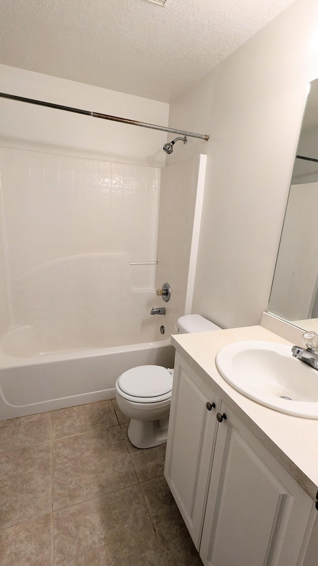 full bathroom featuring a textured ceiling, tub / shower combination, vanity, and toilet