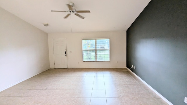 unfurnished room with ceiling fan and light tile patterned floors