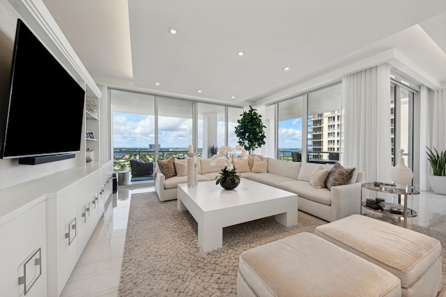 living room featuring floor to ceiling windows and a healthy amount of sunlight