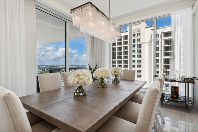 dining room featuring floor to ceiling windows and an inviting chandelier