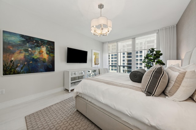 bedroom with an inviting chandelier and light tile patterned flooring