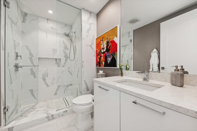 bathroom featuring a shower with door, vanity, and toilet