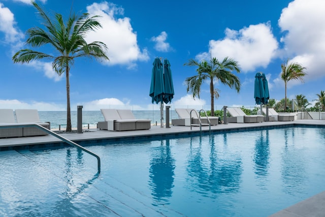 view of swimming pool featuring a water view, outdoor lounge area, and a patio