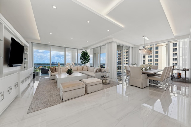 living room featuring a wall of windows and an inviting chandelier