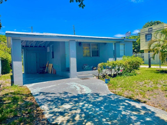611 35th St, West Palm Beach, FL 33407 - view of front of property featuring stucco siding and concrete driveway