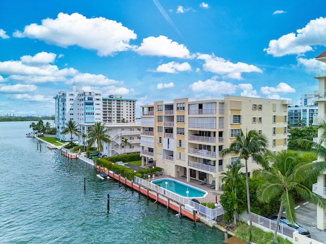 view of property featuring a water view and a community pool