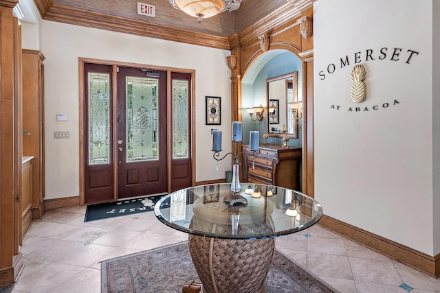 tiled foyer featuring ornamental molding