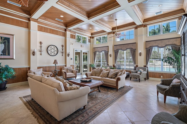 living room with coffered ceiling, beamed ceiling, wood ceiling, and light tile patterned flooring