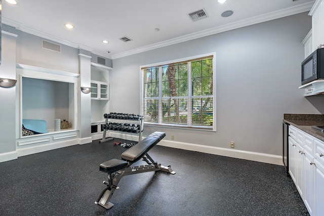 workout room with ornamental molding