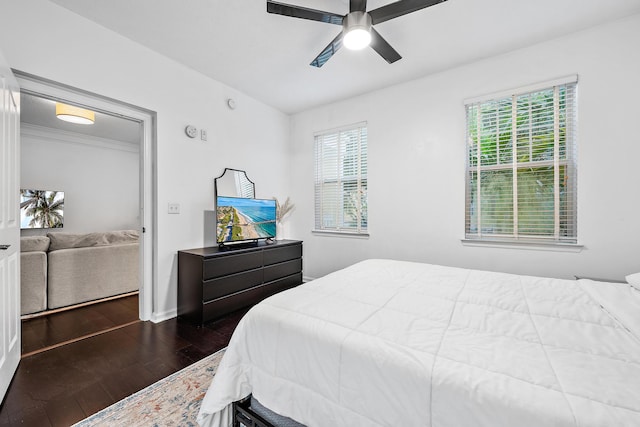 bedroom with ceiling fan and dark hardwood / wood-style floors