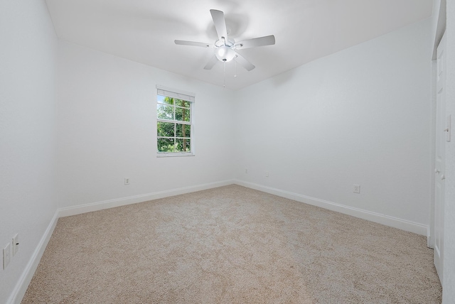 carpeted empty room with ceiling fan