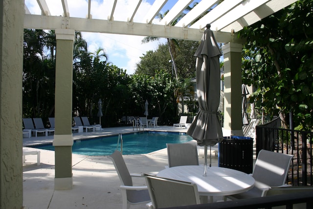 view of swimming pool with a pergola and a patio