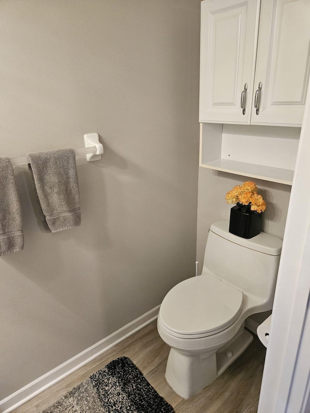 bathroom with hardwood / wood-style floors and toilet