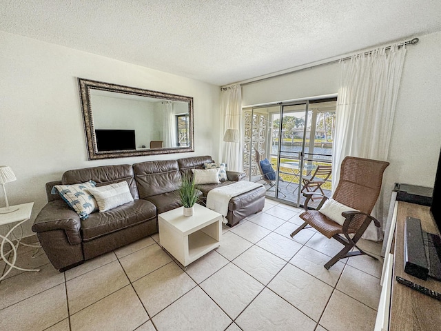 living room with light tile patterned floors and a textured ceiling