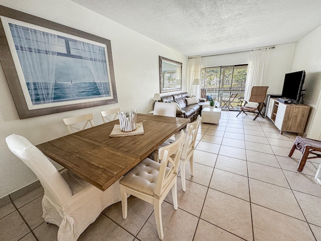 dining area with light tile patterned floors and a textured ceiling