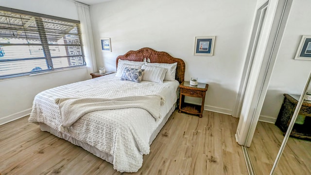 bedroom with light wood-style flooring and baseboards