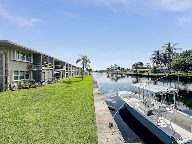 dock area with a lawn and a water view