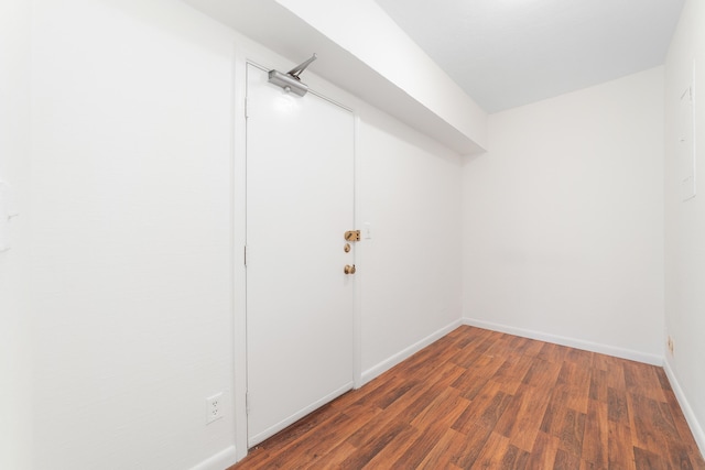 spare room with dark wood-type flooring