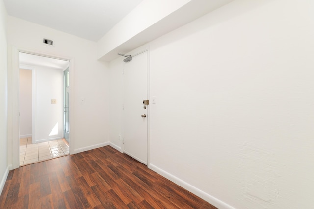 corridor with dark hardwood / wood-style flooring