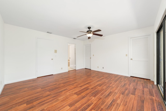 spare room with ceiling fan and dark hardwood / wood-style flooring