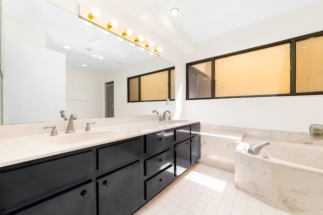 bathroom with vanity, tile patterned floors, and tiled bath