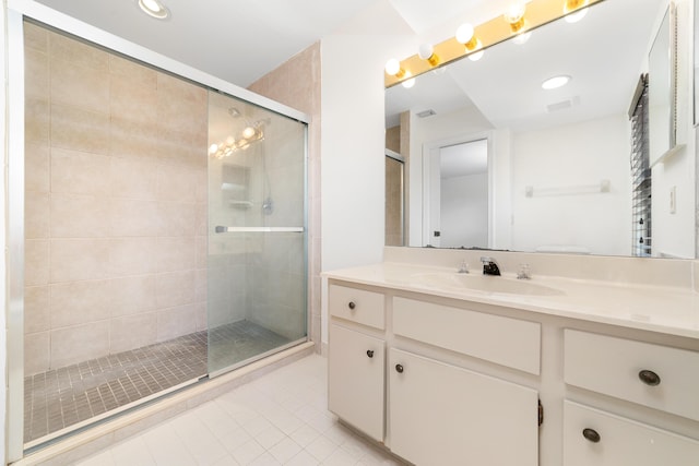 bathroom with vanity, an enclosed shower, and tile patterned flooring